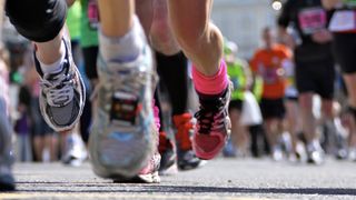 Close-up of people's feet running during a race