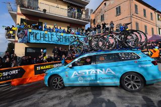The Astana team car stops near a sign honouring Michele Scarponi