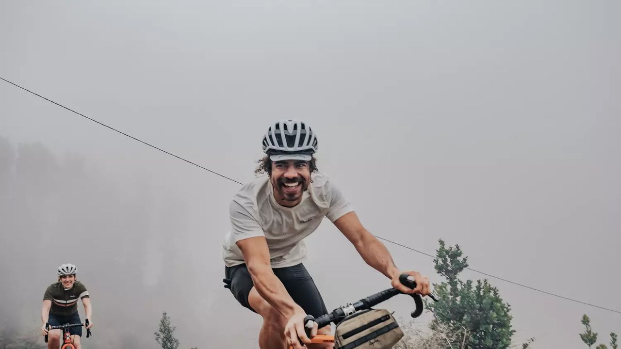 Best bib shorts: Pictured here a smiling cyclist wearing Rapha cycling gear