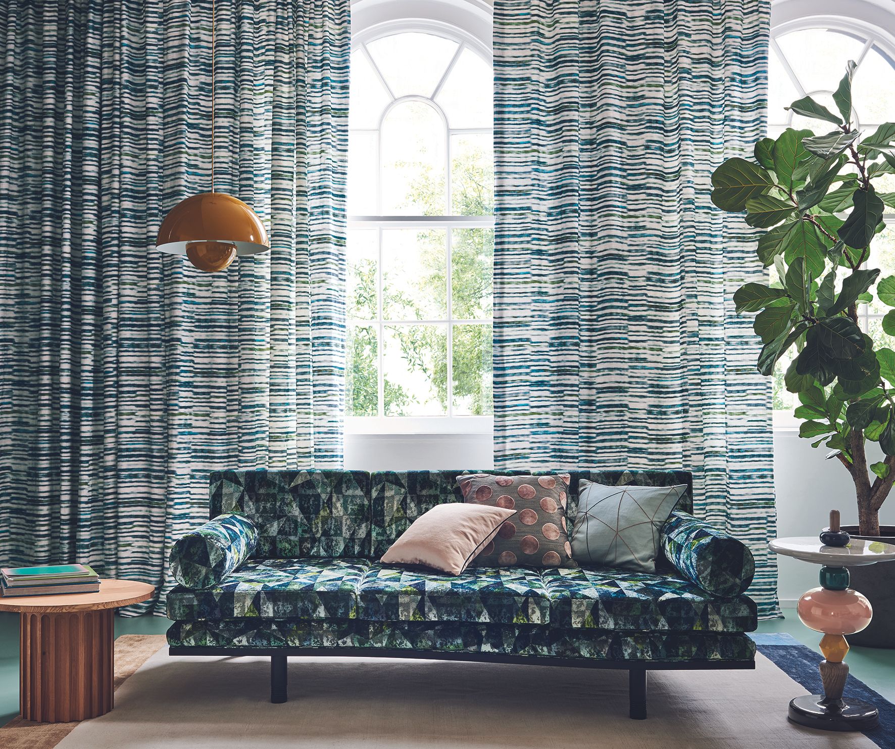 Window treatment with curtains hanging from floor to ceiling