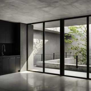 Floor to ceiling glass windows with concrete window frames