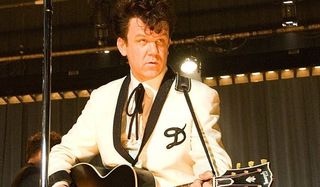 Walk Hard: The Dewey Cox Story John C. Reilly playing guitar on stage