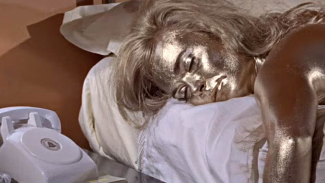 Shirley Eaton covered in gold paint and lying on a bed in Goldfinger