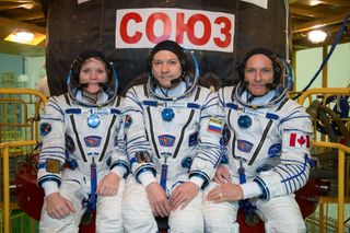 Astronauts Anne McClain of NASA, Oleg Kononenko of Roscosmos and David Saint-Jacques of the Canadian Space Agency pose on Nov. 20 in Kazakhstan before their launch to the International Space Station on Dec. 3, which will kick off an exciting day of activities for NASA.