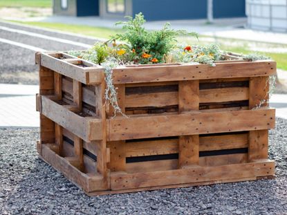 A raised flower bed made of wooden pallets