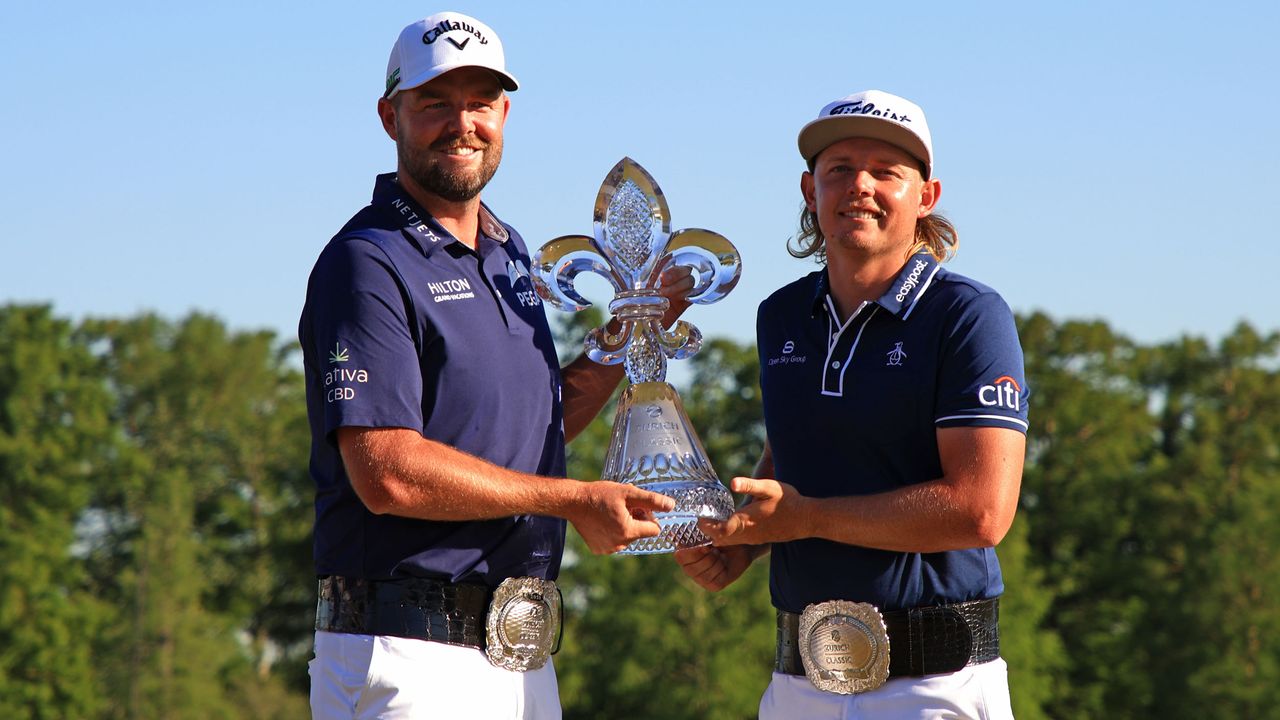 Marc Leishman and Cameron Smith hold a trophy