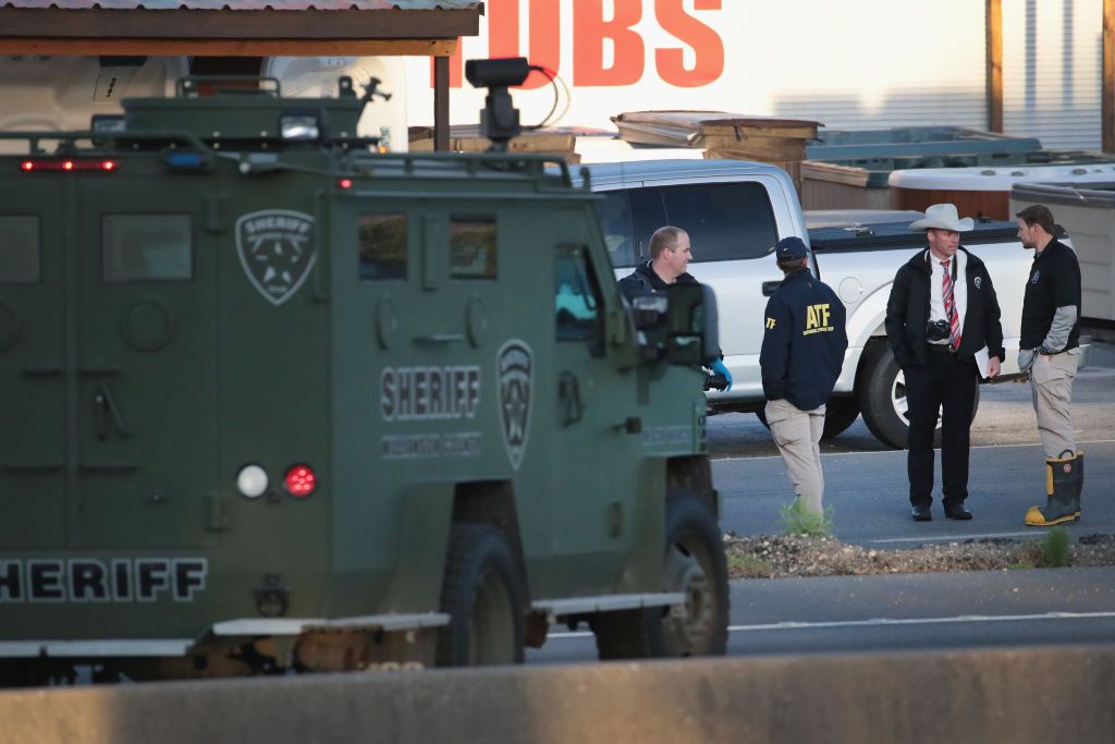 Law enforcement officials search for evidence at the location where the suspected package bomber was killed in suburban Austin on March 21, 2018 in Round Rock, Texas. 