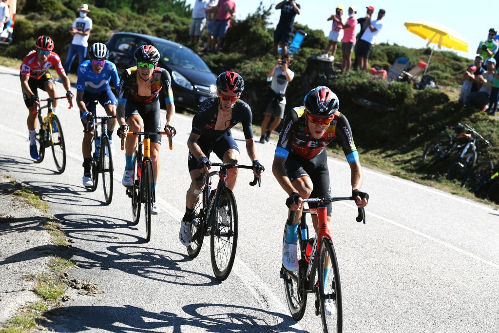MOS SPAIN SEPTEMBER 04 Gino Mder of Switzerland and Team Bahrain Victorious Adam Yates of United Kingdom and Team INEOS Grenadiers Jack Haig of Australia and Team Bahrain Victorious Enric Mas Nicolau of Spain and Movistar Team and Primoz Roglic of Slovenia and Team Jumbo Visma red leader jersey compete in the chase group during the 76th Tour of Spain 2021 Stage 20 a 2022km km stage from Sanxenxo to Mos Alto Castro de Herville 502m lavuelta LaVuelta21 on September 04 2021 in Mos Spain Photo by Tim de WaeleGetty Images