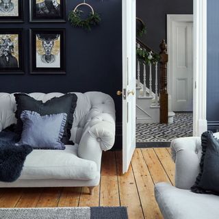 blue living room with white sofa and cushions