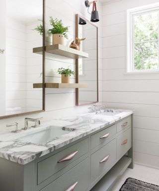 Twin sinks and mirrors, wooden shelves, green drawers