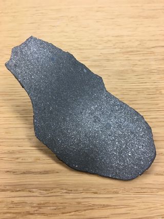 Section of the enstatite chondrite meteorite Sahara 97096. Throughout its formation, Earth accreted material that was isotopically most similar to this group of enstatite meteorites. The dimensions of the section are 10 centimeters by 4 centimeters (4 inches by 1.6 inches).