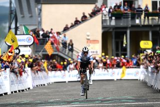 SAINTLARYSOULAN PLA DADET FRANCE JULY 13 Remco Evenepoel of Belgium and Team Soudal QuickStep White best young jersey crosses the finish line as third place winner during the 111th Tour de France 2024 Stage 14 a 1519km stage from Pau to SaintLarySoulan Pla dAdet 1653m UCIWT on July 13 2024 in SaintLarySoulan Pla dAdet France Photo by Tim de WaeleGetty Images