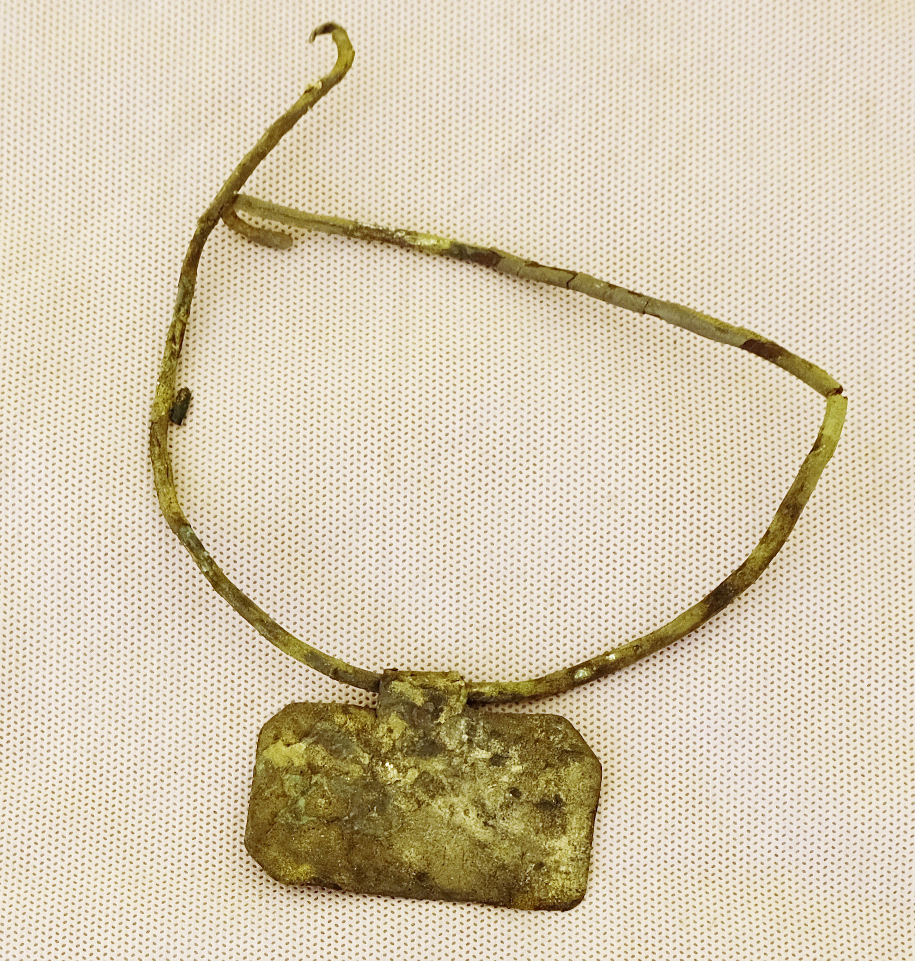 The archaeologists discovered a copper necklace with the inscription 