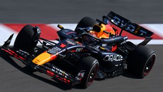 Red Bull driver Max Verstappen of the Netherlands takes a sweeping red and white kerb in the RB20 F1 car