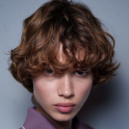 model from stella mccartney with frizz-free smooth hair, that looks like she might have used one of the best hair creams