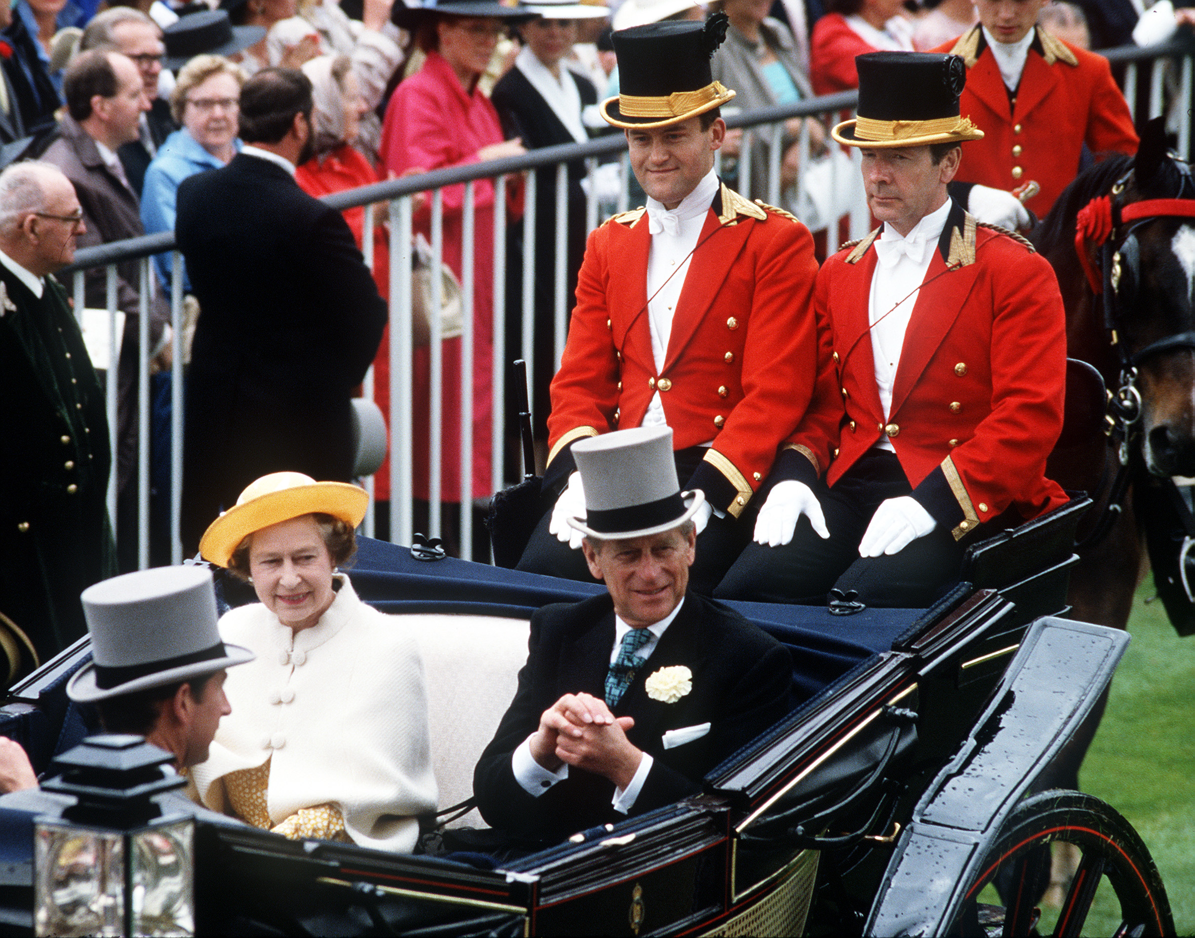 Queen Elizabeth and Prince Philip riding in a carriage with Paul Burrell