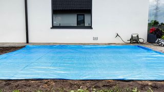 Blue tarp on ground