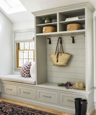 Mudroom with wood floor and rug and built-in cabinets in gray