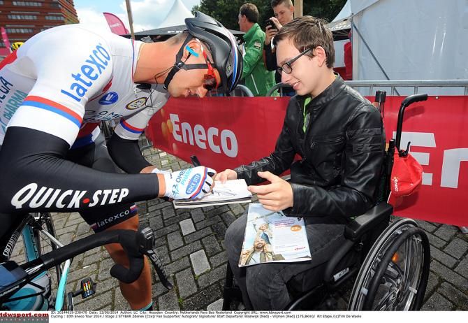 Omega Pharma-QuickStep's Stybar signs autographs before the start of stage 2