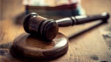 A judge's gavel sitting on its block.