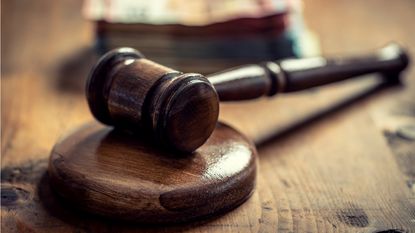 A judge's gavel sitting on its block.