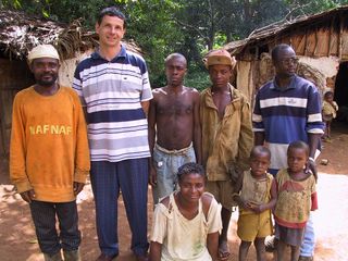 Study researcher Alain Froment, of the Museum of Man in France, in the striped shirt with a group of Pygmies.