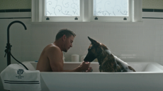 Channing Tatum and a dog sit in a bathtub