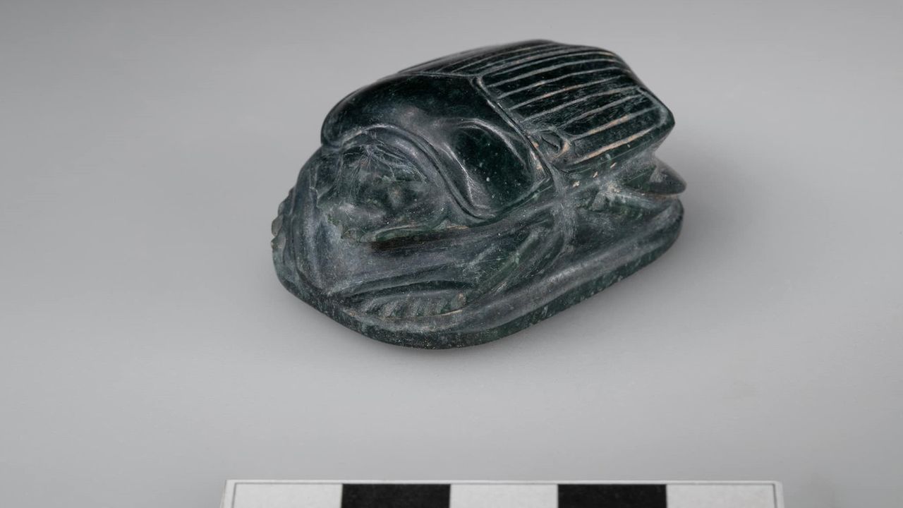 A small black scarab-shaped amulet that was found in an Egyptian tomb.