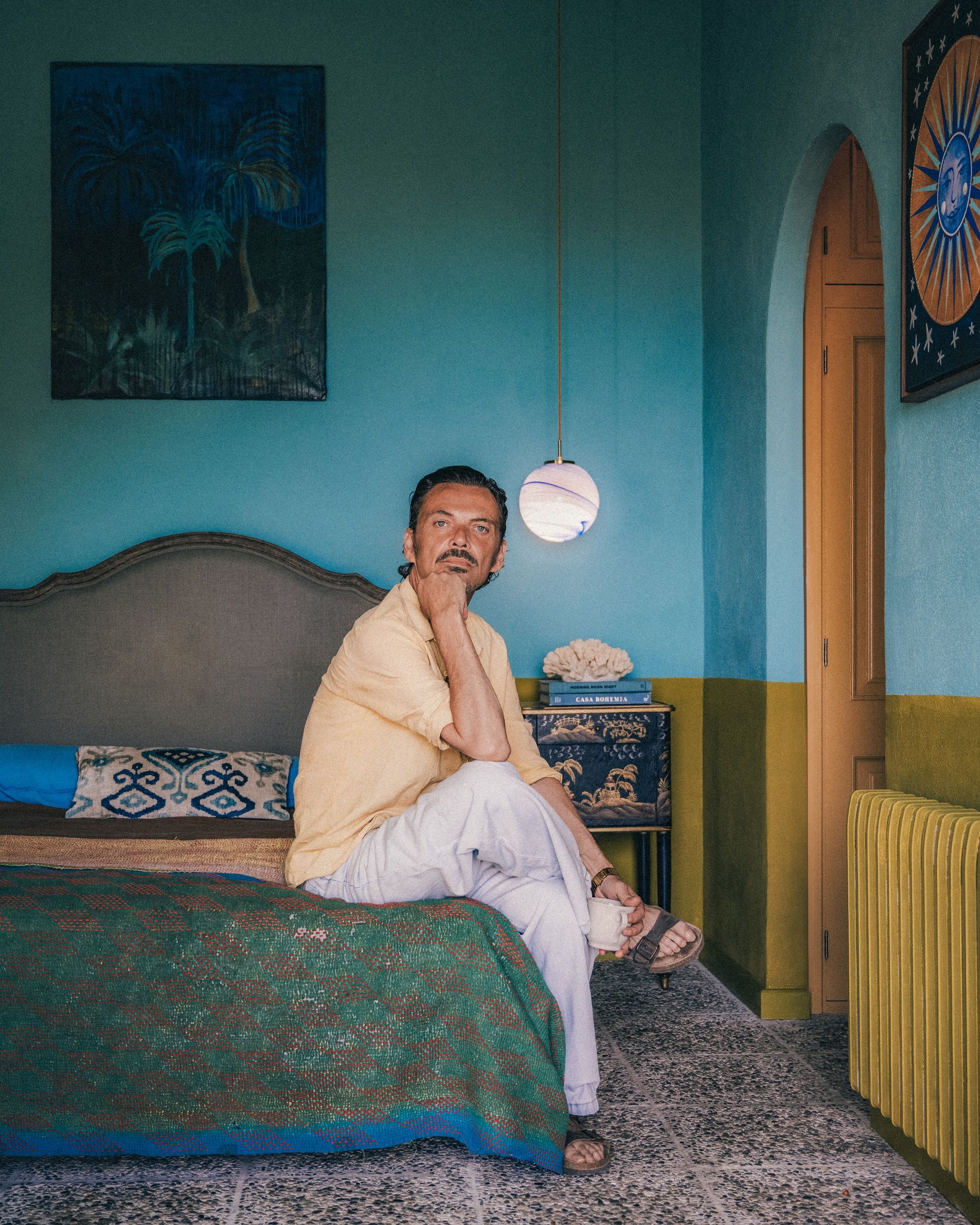 matthew williamson in a blue and tellow painted bedroom