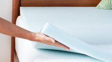 One of the best cheap mattress toppers, the Linenspa Memory Foam Mattress Topper on a bed