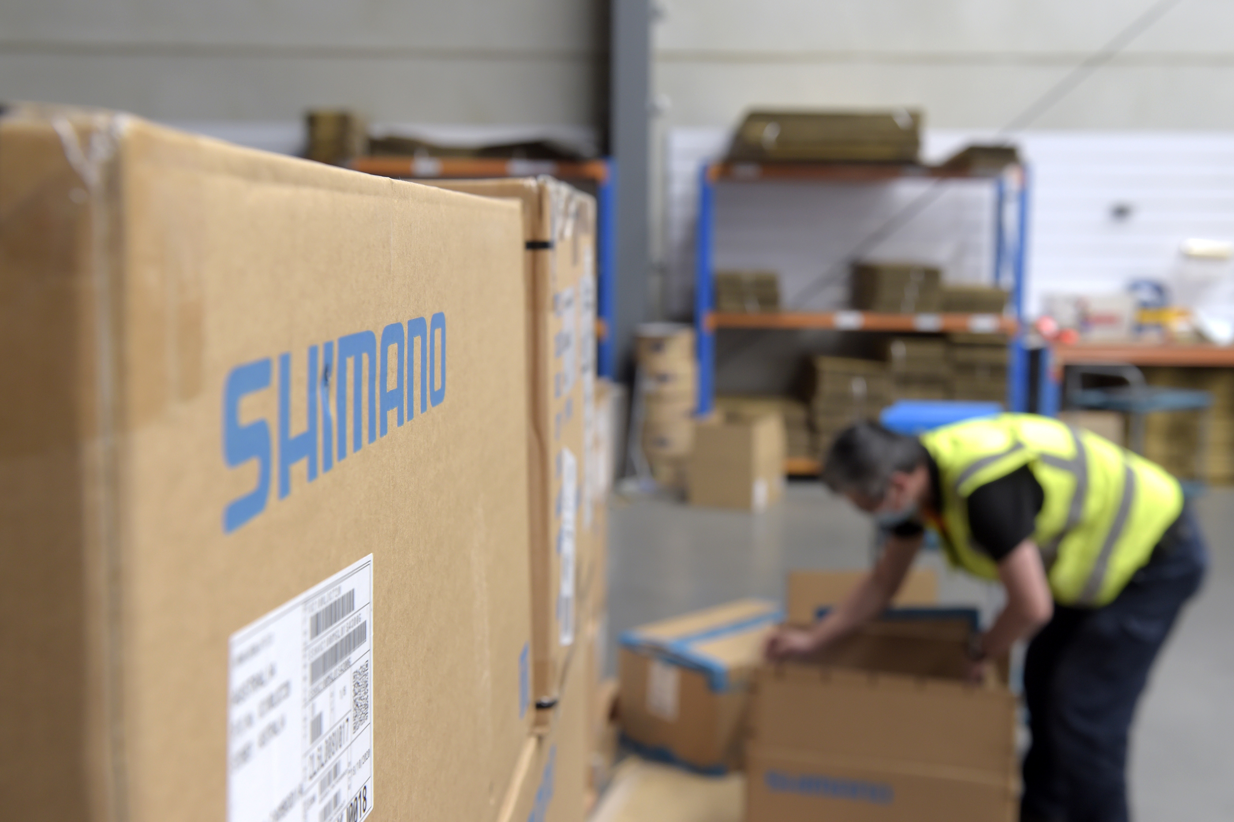 An employee unpacks newly arrived boxes of Shimano Inc. accessories at the online store's office and warehouse in Dandenong, Victoria, Australia, on Thursday, Dec. 10, 2020. Photographer: Carla Gottgens/Bloomberg