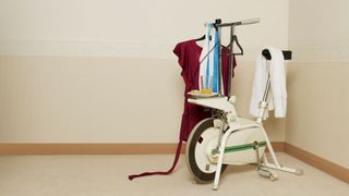 An old exercise bike doubles as a clothes stand