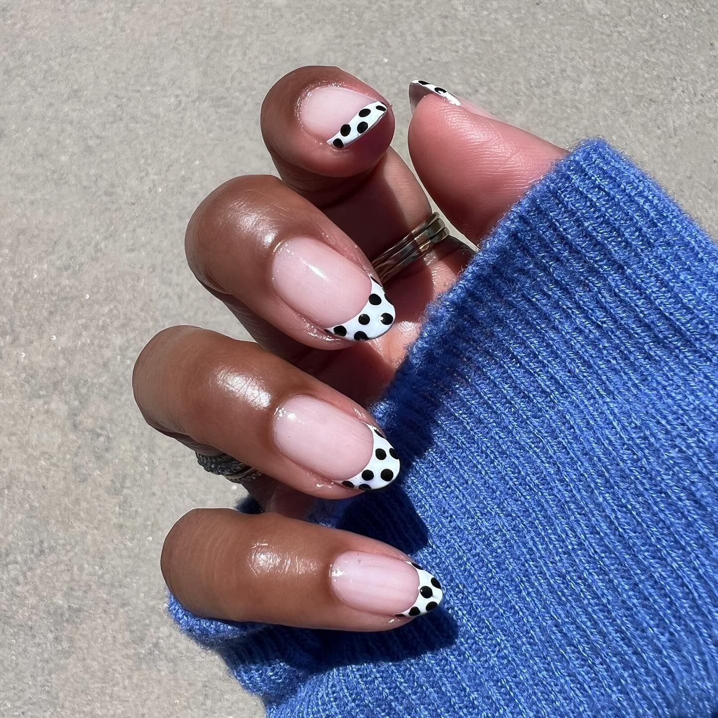 A black and white polka dot French manicure