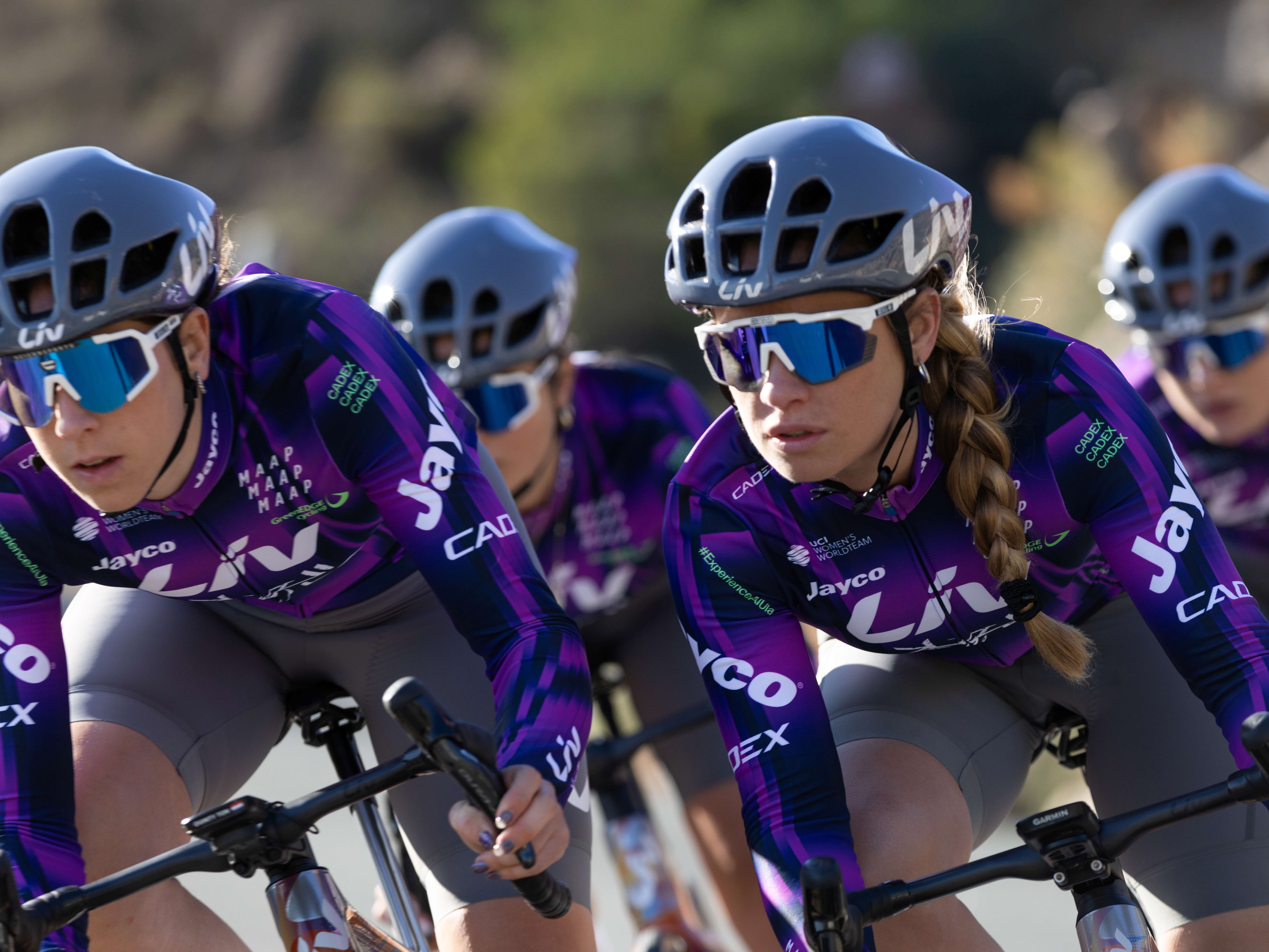 Four cyclists turn a corner