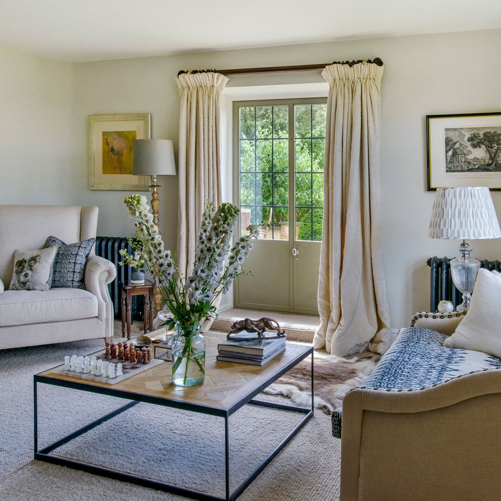 white living room with sofa set and carpet flooring