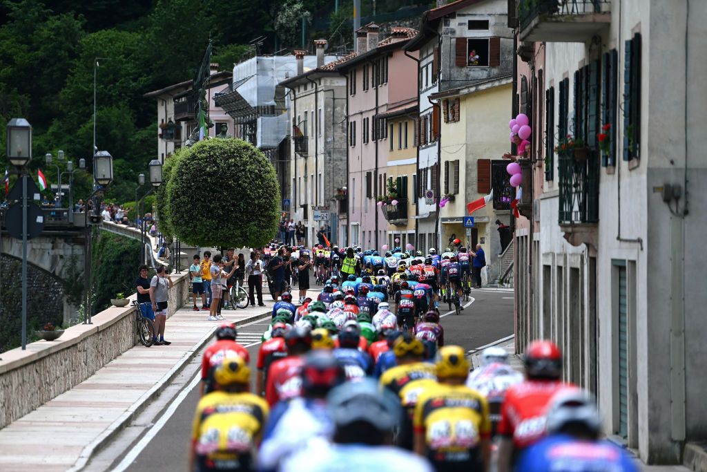 CAORLE ITALY MAY 24 A general view of the peloton passing through Bassano del Grappa Village during the the 106th Giro dItalia 2023 Stage 17 a 197km stage from Pergine Valsugana to Caorle UCIWT on May 24 2023 in Caorle Italy Photo by Tim de WaeleGetty Images