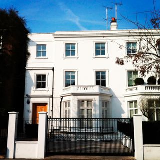 white building with glass windows and black front gate