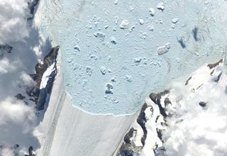 A year later, in February 2003, with the ice shelf gone, the Crane glacier's edge has retreated inland.