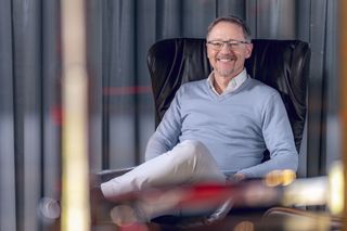 Reidels Anthony Zuyderhoff smiling while sitting in a chair.