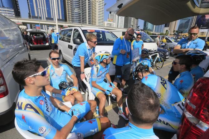 The Astana team hold a meeting before the start of stage 3 in Dubai
