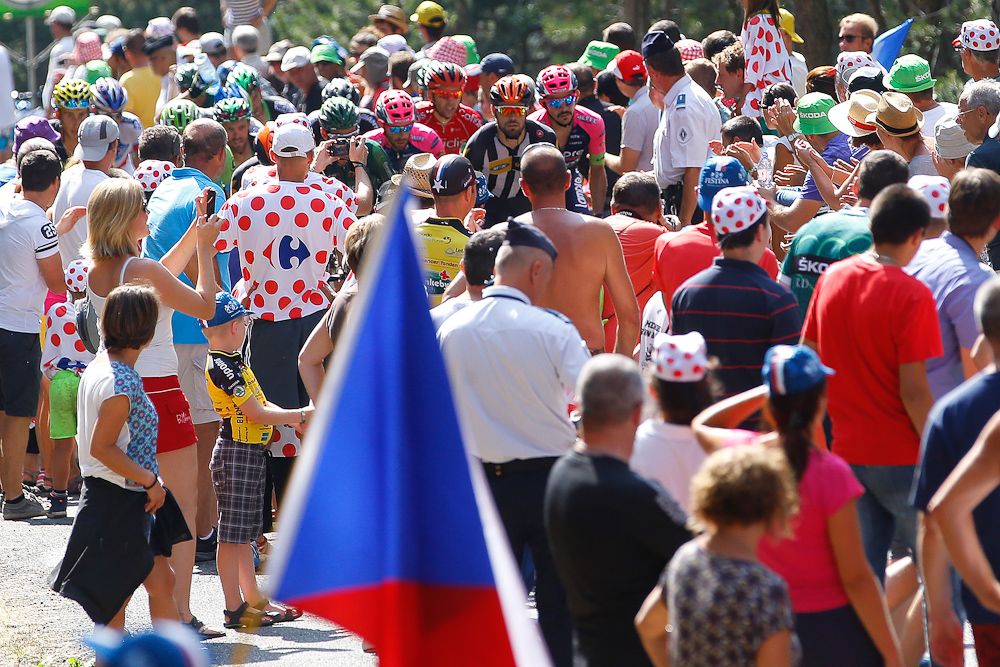 Riders can hardly be seen among the spectators.