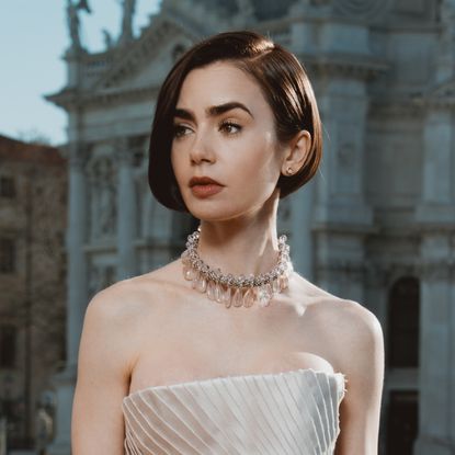 Lily Collins wearing a Schiaparelli Haute Couture gown at the Emily in Paris season 5 photocall