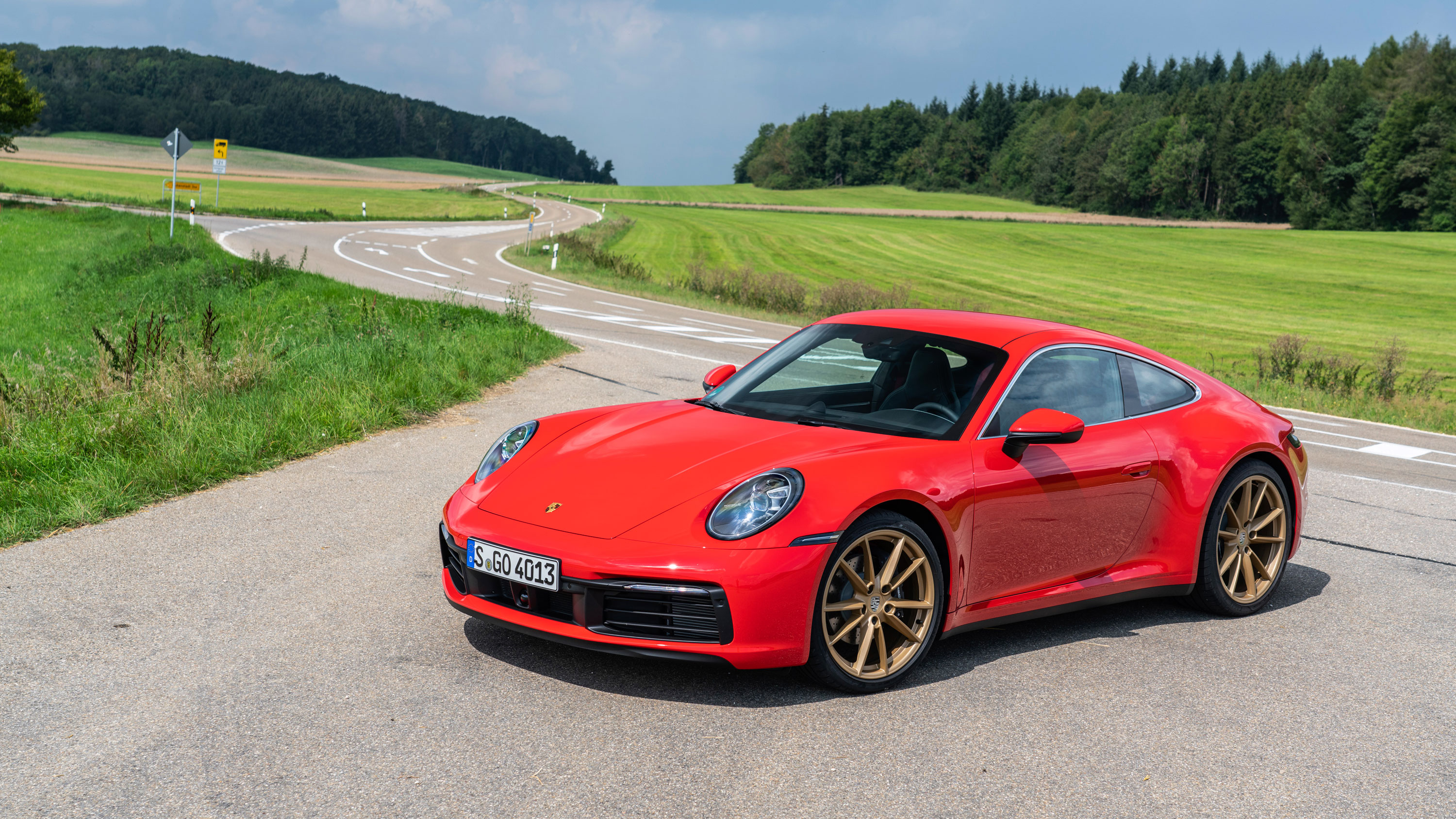 Porsche 911 (992) parked on the bend of a country road