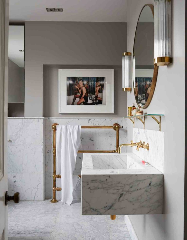 marble bathroom with brass accents