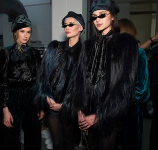Models wearing black fur jacket and shades at Fashion Week Women’s at Milan by Emporio Armani A/W 2020