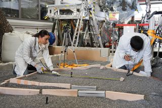 NASA engineer Marleen Sundgaard (left) and Pranay Mishra take measurements of the "Martian rock garden" at NASA's Jet Propulsion Laboratory in Pasadena, California.