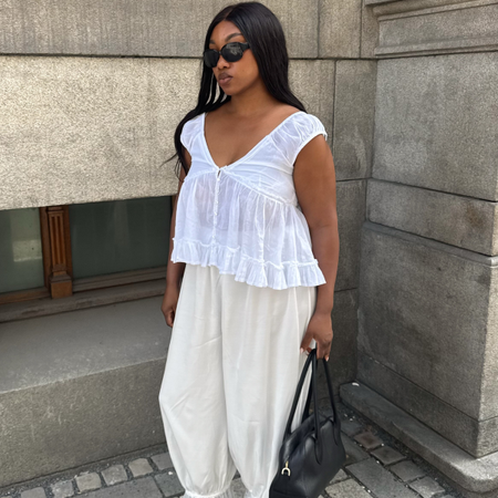 An image of a woman wearing best white linen fashion item for summer 2026