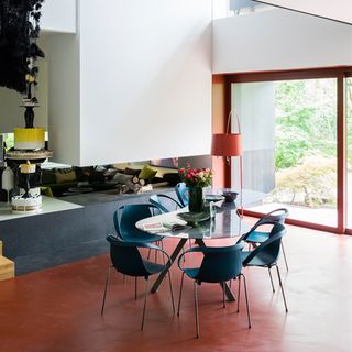 dining table with flower vase on red floor