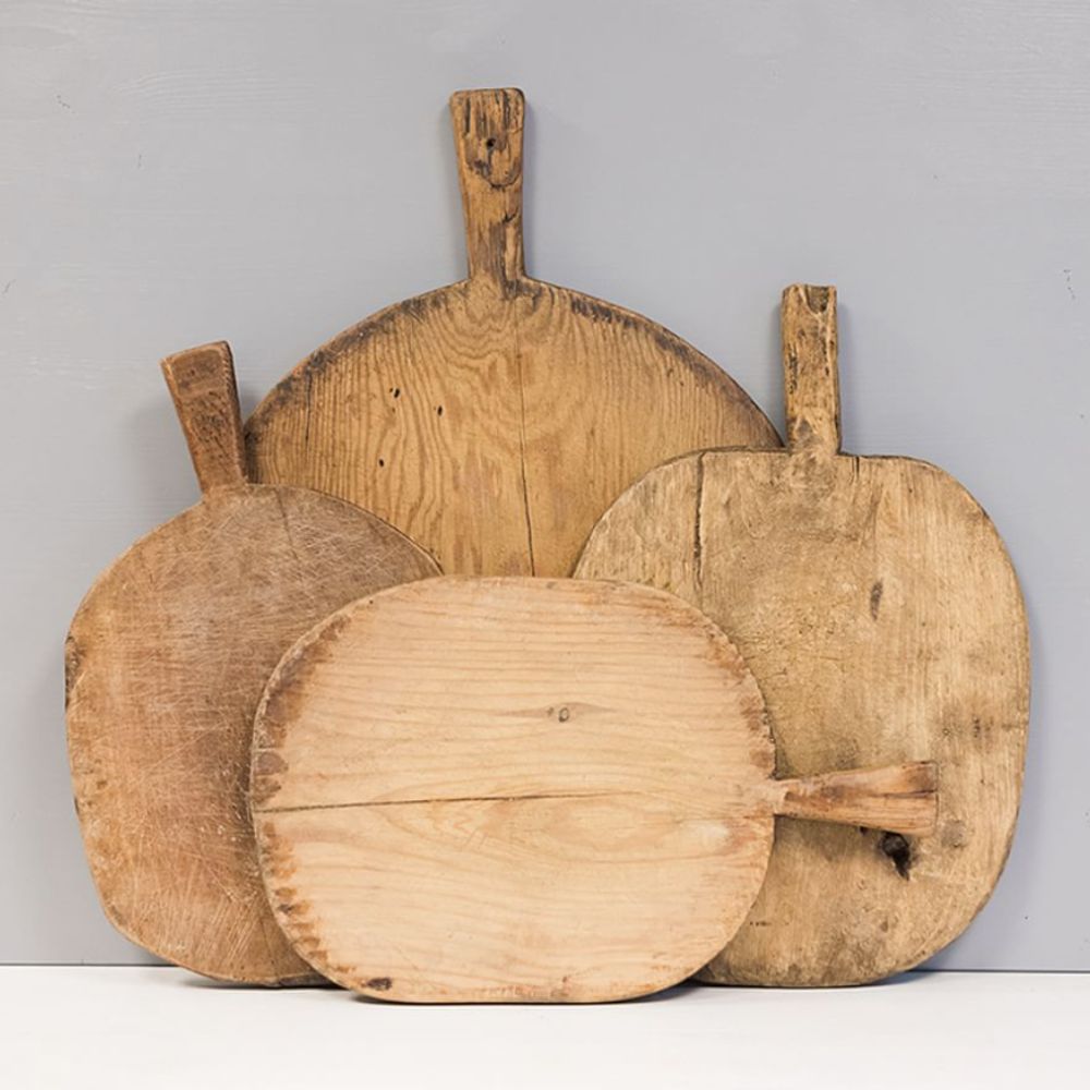 Four different shaped wooden serving boards with handles