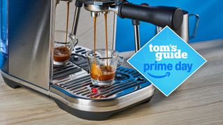 the breville bambino plus espresso machine pulling a shot of espresso with a tom's guide blue diamond deal badge